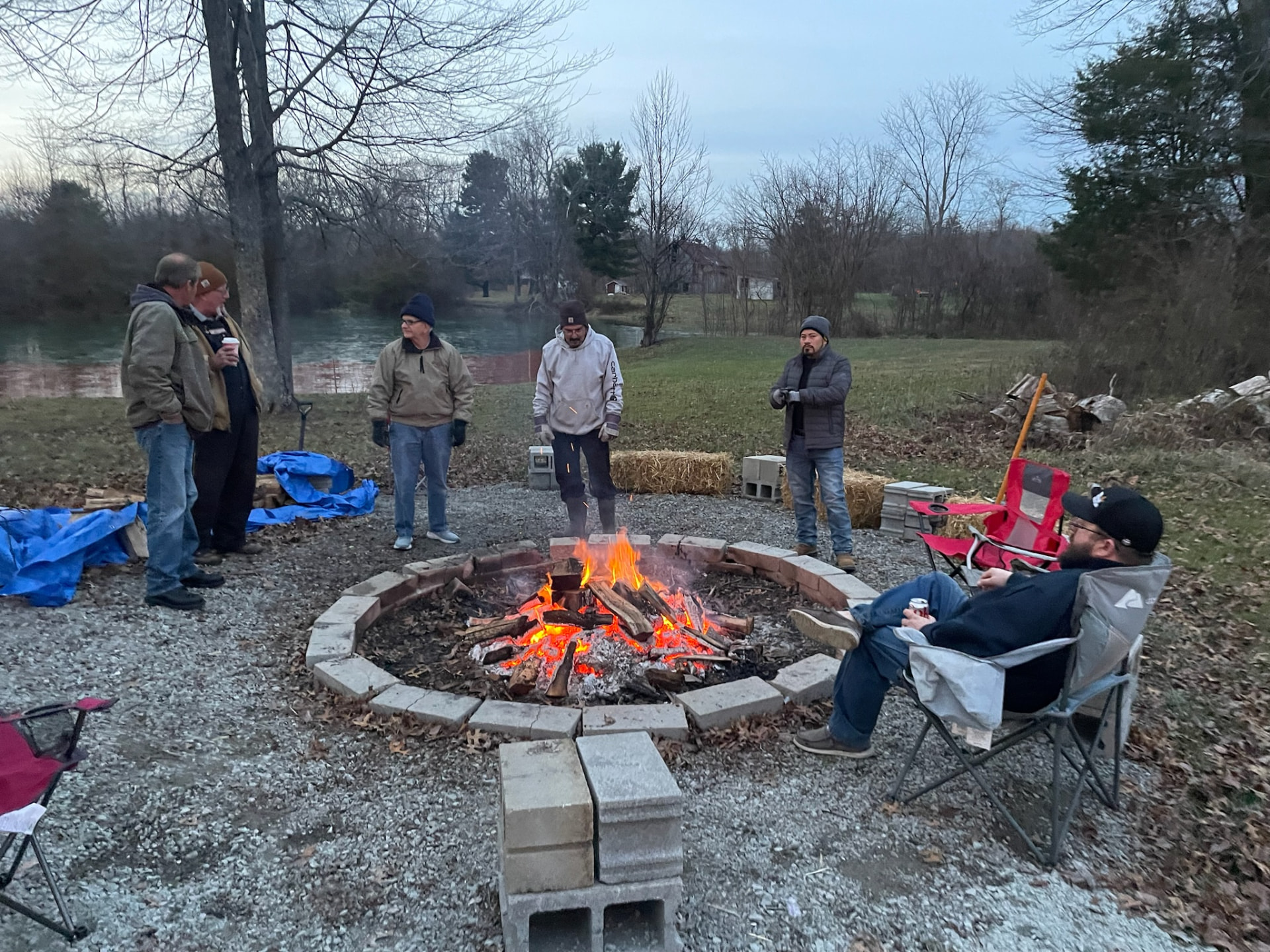 Families gathered around the bonfire with warm drinks