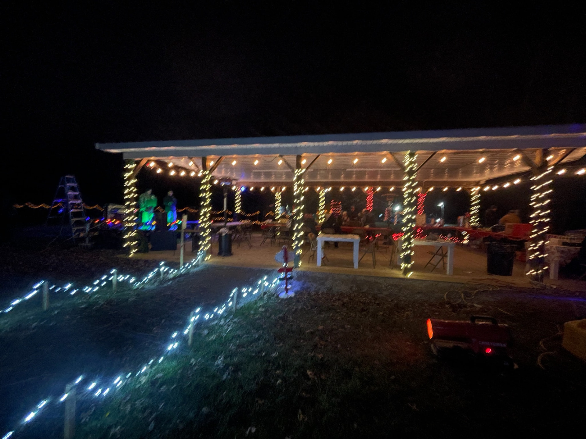 Festival pavilion glowing with warm string lights at night