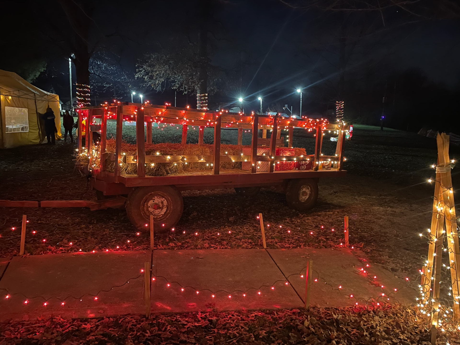Hayride wagon wrapped in festive red lights
